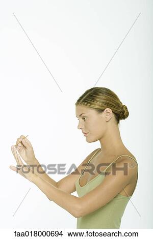 Young woman cleaning cuticles View Large Photo Image Picture - Young woman cleaning cuticles. Fotosearch