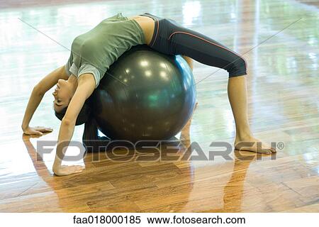 Young woman doing backbend on fitness ball View Large Photo Image Stock Photography - Young woman doing backbend on fitness ball. Fotosearch