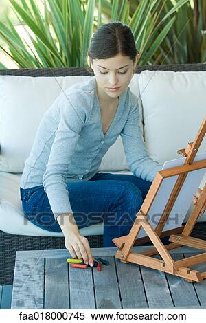 Young woman drawing with easel View Large Photo Image Stock Photography - Young woman drawing with easel. Fotosearch