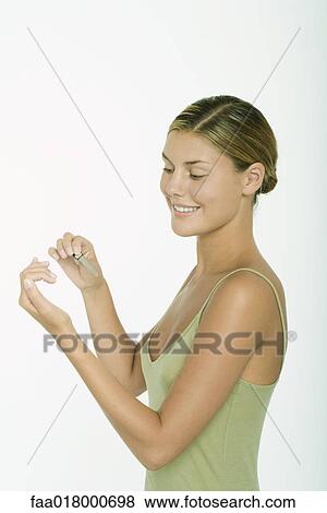 Stock Photo - Young woman filing fingernails. Fotosearch