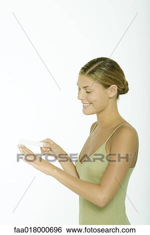 Stock Photograph - Young woman filing fingernails. Fotosearch