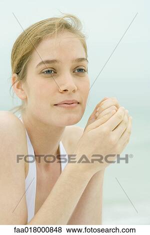 Young woman, head and shoulders, portrait, sea in background View Large Photo Image Stock Photo - Young woman, head and shoulders, portrait, sea in background. Fotosearch