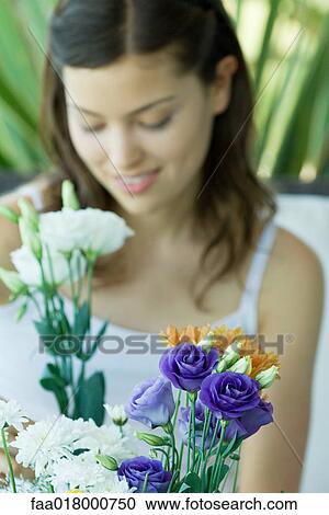 Young woman making fresh flower arrangement View Large Photo Image Stock Image - Young woman making fresh flower arrangement. Fotosearch