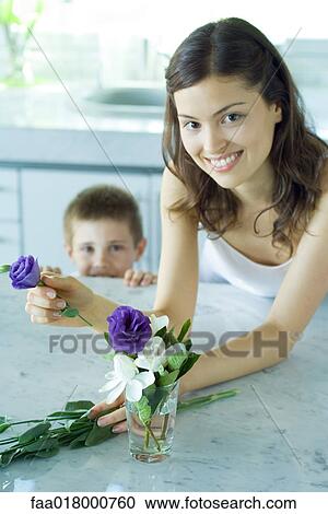 Young woman making fresh flower arrangement, next to boy, smiling View Large Photo Image Stock Image - Young woman making fresh flower arrangement, next to boy, smiling. Fotosearch