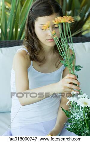 Stock Photo - Young woman making fresh flower arrangement. Fotosearch