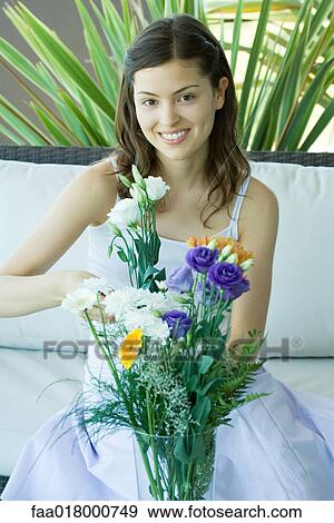 Stock Photo - Young woman making fresh flower arrangement. Fotosearch
