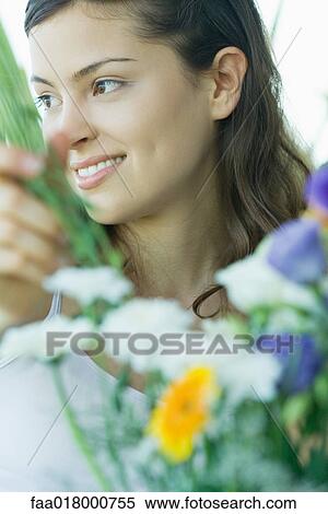 Young woman making fresh flower arrangement View Large Photo Image Stock Photography - Young woman making fresh flower arrangement. Fotosearch