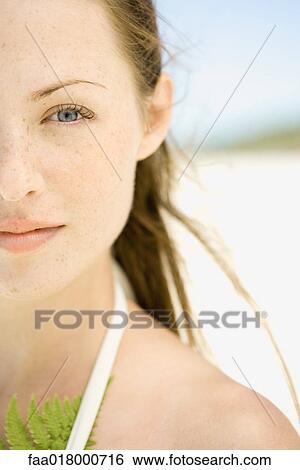 Stock Photograph - Young woman on beach, cropped view. Fotosearch