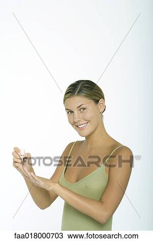 Young woman polishing nails View Large Photo Image Stock Image - Young woman polishing nails. Fotosearch