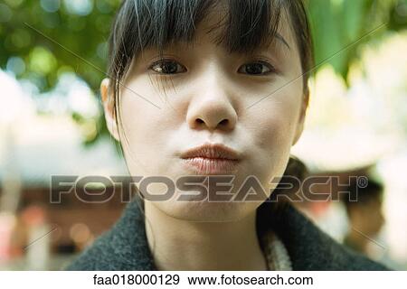 Young woman puckering lips View Large Photo Image Stock Photo - Young woman puckering lips. Fotosearch