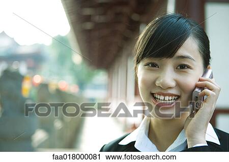 Young woman using cell phone, close-up View Large Photo Image Stock Image - Young woman using cell phone, close-up. Fotosearch
