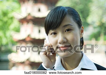 Young woman using cell phone, close-up View Large Photo Image Stock Image - Young woman using cell phone, close-up. Fotosearch