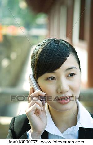 Young woman using cell phone, close-up View Large Photo Image Stock Photo - Young woman using cell phone, close-up. Fotosearch