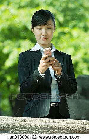 Young woman using cell phone View Large Photo Image Stock Image - Young woman using cell phone. Fotosearch