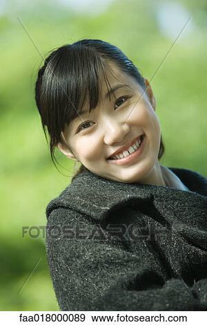Young woman wearing coat, portrait View Large Photo Image Stock Photo - Young woman wearing coat, portrait. Fotosearch
