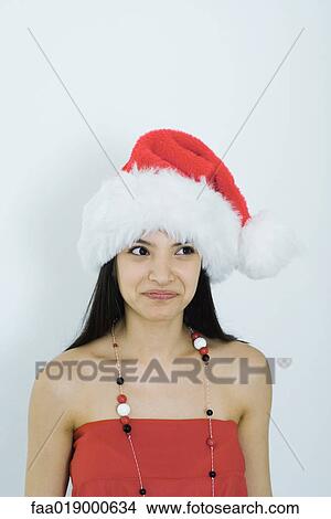 Young woman wearing santa hat, portrait View Large Photo Image Picture - Young woman wearing santa hat, portrait. Fotosearch