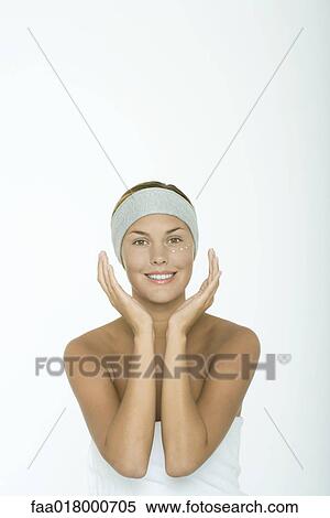 Young woman with dots of moisturizer under eye, hands around face View Large Photo Image Stock Photography - Young woman with dots of moisturizer under eye, hands around face. Fotosearch