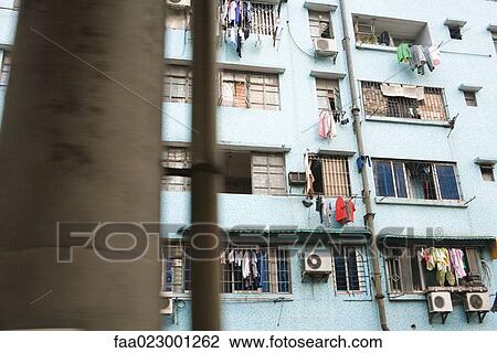 Apartment building with laundry hanging in front of windows View Large Photo Image Stock Image - Apartment building with laundry hanging in front of windows. Fotosearch