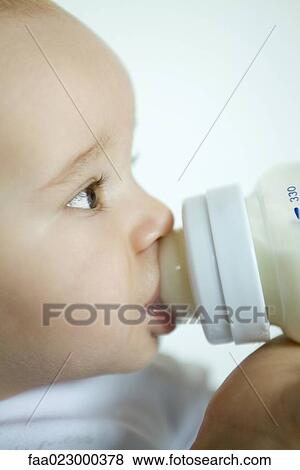 Baby drinking from bottle, extreme close-up, side view View Large Photo Image Stock Photo - Baby drinking from bottle, extreme close-up, side view. Fotosearch