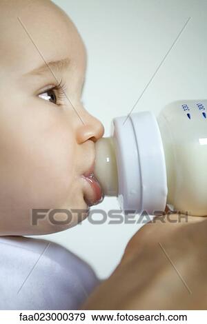 Baby drinking from bottle, extreme close-up, side view View Large Photo Image Stock Photo - Baby drinking from bottle, extreme close-up, side view. Fotosearch