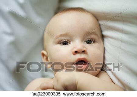 Baby in bed, head and shoulders, close-up View Large Photo Image Stock Photography - Baby in bed, head and shoulders, close-up. Fotosearch