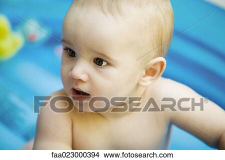Baby in inflatable baby pool, head and shoulders, close-up View Large Photo Image Picture - Baby in inflatable baby pool, head and shoulders, close-up. Fotosearch