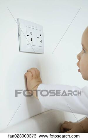 Baby looking at electrical outlet View Large Photo Image Stock Image - Baby looking at electrical outlet. Fotosearch