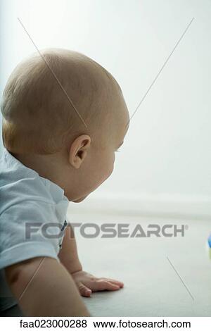 Baby on floor, head and shoulders View Large Photo Image Stock Photo - Baby on floor, head and shoulders. Fotosearch