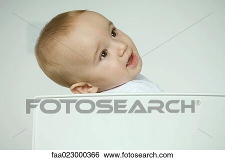 Baby sitting in chair, leaning head back View Large Photo Image Stock Photograph - Baby sitting in chair, leaning head back. Fotosearch