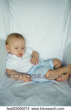 Baby sleeping in arm chair, portrait View Large Photo Image Stock Image - Baby sleeping in arm chair, portrait. Fotosearch