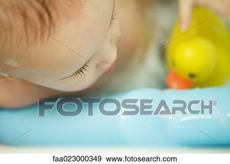 Baby taking bath, extreme close-up, cropped view View Large Photo Image Stock Photo - Baby taking bath, extreme close-up, cropped view. Fotosearch