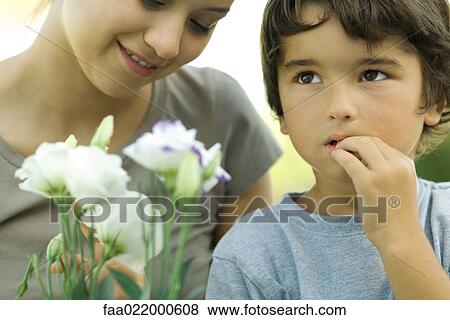 Boy and young woman with flowers, boy looking up View Large Photo Image Stock Photo - Boy and young woman with flowers, boy looking up. Fotosearch