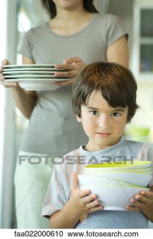 Boy helping mother set table, portrait View Large Photo Image Stock Image - Boy helping mother set table, portrait. Fotosearch