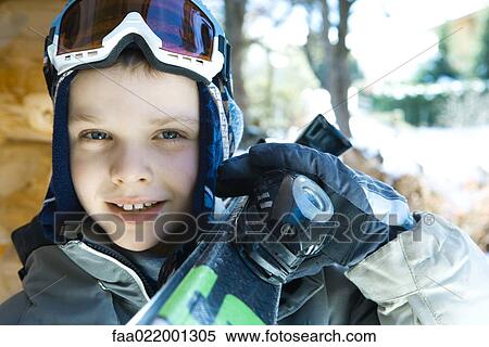 Boy holding skis on shoulder, portrait View Large Photo Image Stock Photography - Boy holding skis on shoulder, portrait. Fotosearch