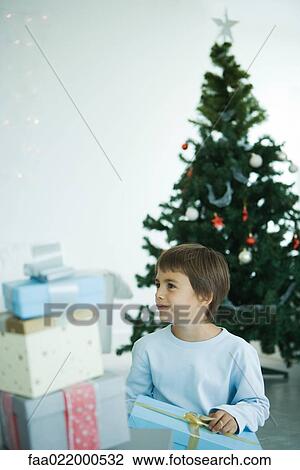 Boy opening Christmas presents View Large Photo Image Stock Image - Boy opening Christmas presents. Fotosearch