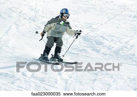 Boy skiing down ski slope, full length View Large Photo Image Stock Photography - Boy skiing down ski slope, full length. Fotosearch