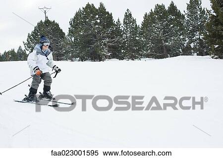 Boy skiing, full length View Large Photo Image Stock Photography - Boy skiing, full length. Fotosearch
