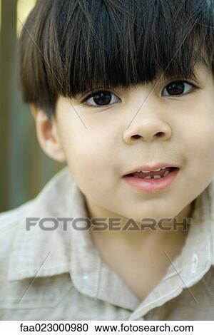 Stock Image - Boy smiling at camera, portrait. Fotosearch