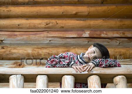 Boy standing on deck of wood cabin, leaning on rail View Large Photo Image Stock Image - Boy standing on deck of wood cabin, leaning on rail. Fotosearch