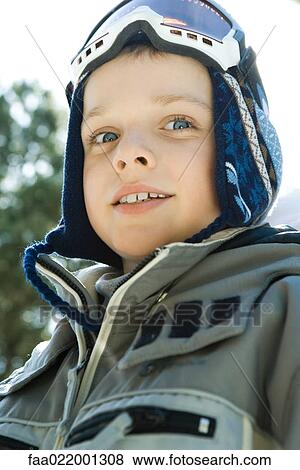 Boy wearing ski gear, looking at camera, low angle view, portrait View Large Photo Image Stock Photo - Boy wearing ski gear, looking at camera, low angle view, portrait. Fotosearch