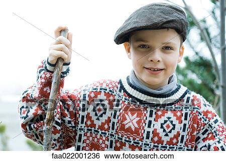 Boy wearing traditional sweater and cap, holding hiking stick View Large Photo Image Stock Photograph - Boy wearing traditional sweater and cap, holding hiking stick. Fotosearch