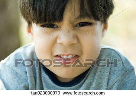 Boy wrinkling nose at camera, portrait View Large Photo Image Stock Photo - Boy wrinkling nose at camera, portrait. Fotosearch