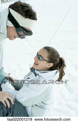 Brother and sister face to face in snow, brother bending over, sister sitting on the ground View Large Photo Image Stock Photo - Brother and sister face to face in snow, brother bending over, sister sitting on the ground. Fotosearch
