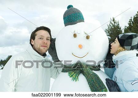 Brother and sister leaning against snowman, sister whispering, brother listening View Large Photo Image Stock Photo - Brother and sister leaning against snowman, sister whispering, brother listening. Fotosearch