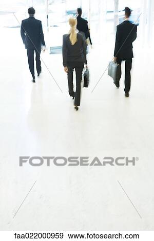 Business associates exiting lobby, rear view, blurred motion View Large Photo Image Stock Photo - Business associates exiting lobby, rear view, blurred motion. Fotosearch
