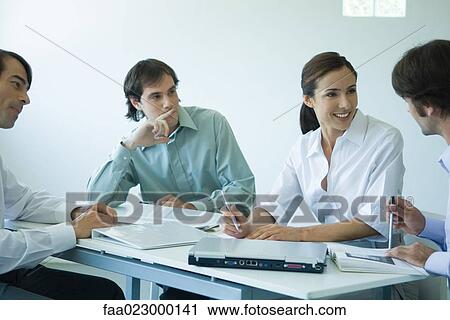 Business associates seated at table, chatting, cropped view View Large Photo Image Stock Image - Business associates seated at table, chatting, cropped view. Fotosearch