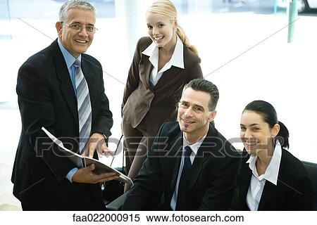 Business associates smiling at camera, group portrait View Large Photo Image Stock Photography - Business associates smiling at camera, group portrait. Fotosearch