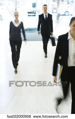 Business professionals walking in lobby, full length, blurred motion View Large Photo Image Stock Photo - Business professionals walking in lobby, full length, blurred motion. Fotosearch