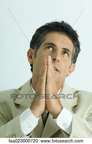Businessman praying, looking up, portrait View Large Photo Image Stock Image - Businessman praying, looking up, portrait. Fotosearch