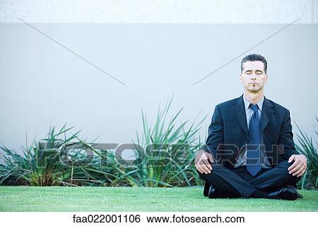 Businessman sitting on ground outdoors, meditating, eyes closed View Large Photo Image Stock Photograph - Businessman sitting on ground outdoors, meditating, eyes closed. Fotosearch